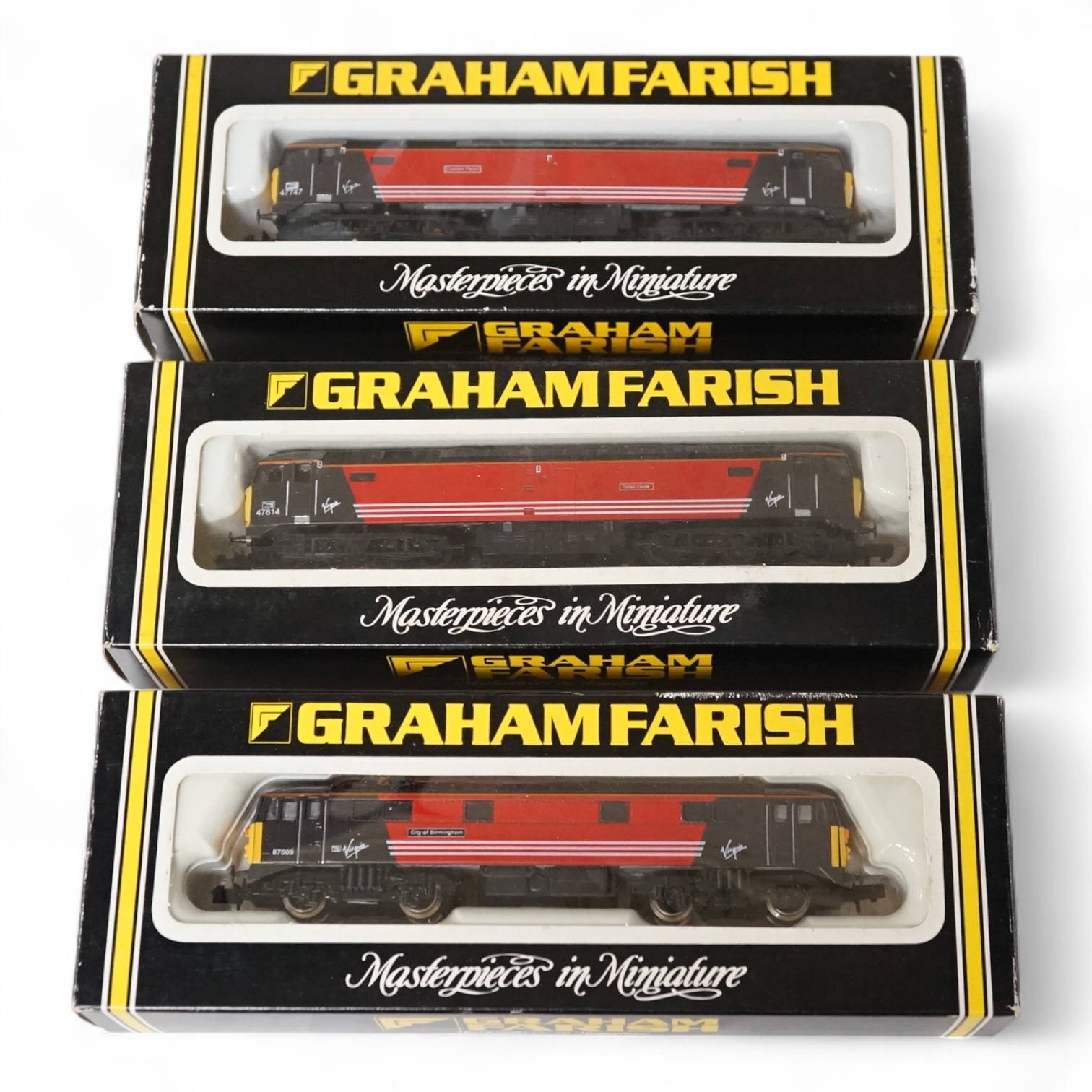 Three boxed Graham Farish N gauge railway locomotives in Virgin Trains livery; a class 47 Graham Farish 47747 (FA80211), a class 47 Totnes Castle 47814 (800A), and a class 87 City of Birmingham 87009 (883A). Condition -